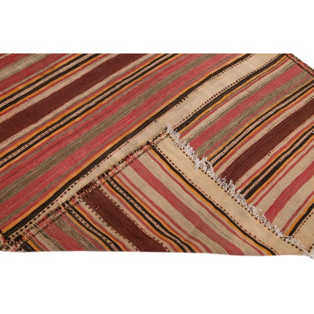 Beautiful vintage Turkish Kilim hand-knotted wool rug with a beige field. This piece has multicolor accents in an all-over...
