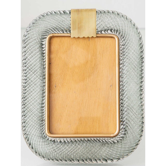 A weighty smoke grey murano glass picture frame, the border hand-twisted in the torciglione technique and set in a gilt-...