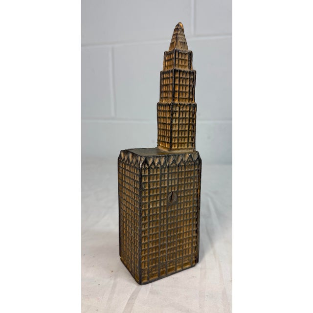 The Antique 1910's Gold tone Cast Iron Still Coin Penny Bank by Kenton is a rare and original collectible piece from the...