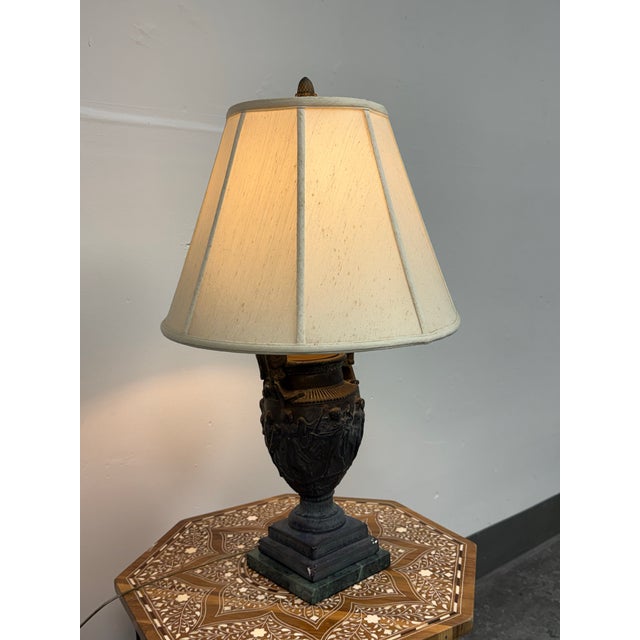 Design Plus Gallery presents a Neoclassical Figural Urn Table Lamp. This table lamp has an urn-form body with raised...