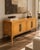 An exquisite 1970s Hollywood Regency credenza attributed to Mastercraft, distinguished by its richly figured burlwood...