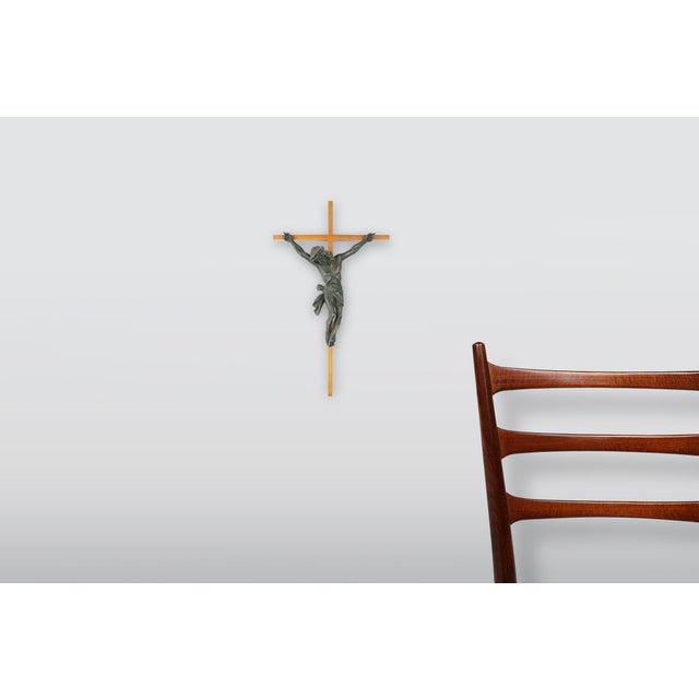 A striking French crucifix from around 1850, carved in wood with expressive Baroque detailing. The figure of Christ is...