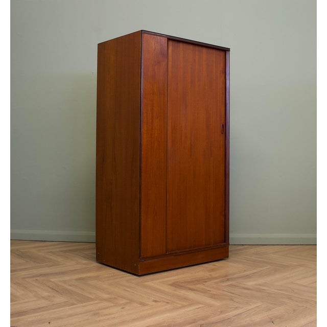 A freestanding teak wardrobe from Austinsuite - standing castors These Austinsuite wardrobes have a unique design feature...