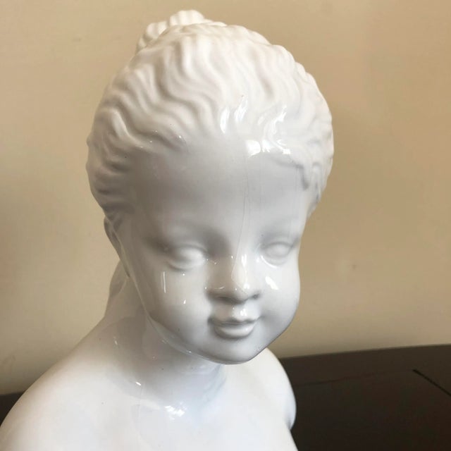 A vintage white Italian pottery bust of a young girl. Marked 'Italy.'