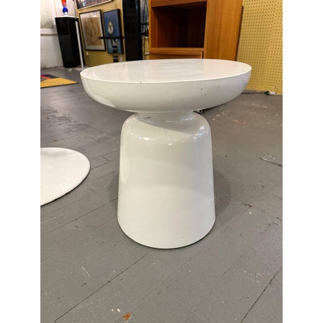 Minimalist yet inviting, this modernist side table features a bold drum-shaped profile topped with a shallow, gently...