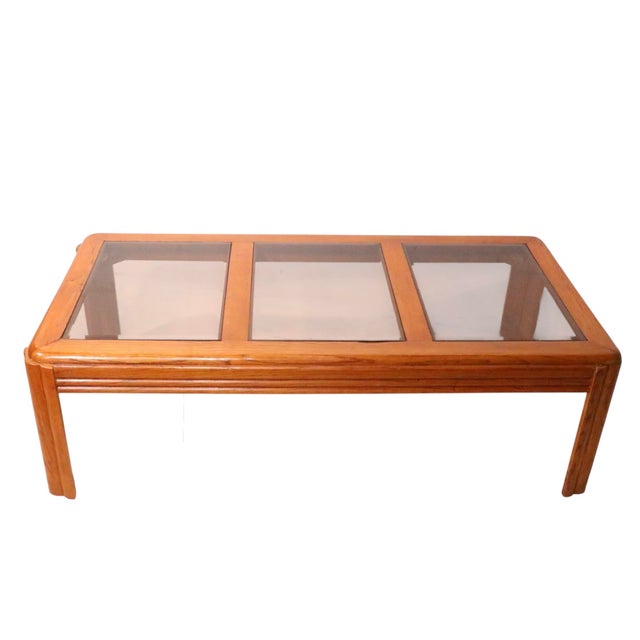 Postmodern coffee table constructed of solid oak, with three square tinted glass panels. The table is in excellent,...