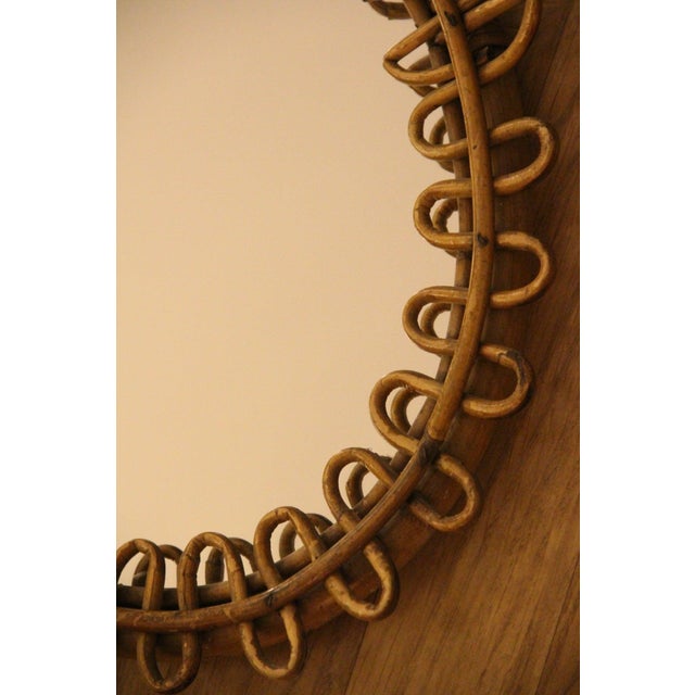 This highly decorative mirror was made in Italy in the 1960s. It is typical of the design of that period and is entirely...