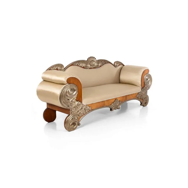 A commanding and elegant early 19th century Spanish salon sofa. Carved in birch and giltwood, the generously padded back...