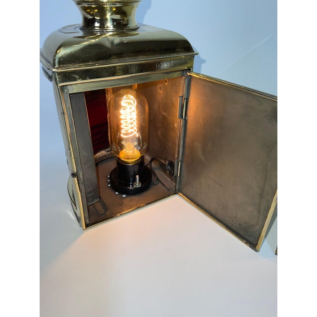 Choice pair of antique port and starboard lanterns with deep red and blue fresnel glass lenses. The brass has been...