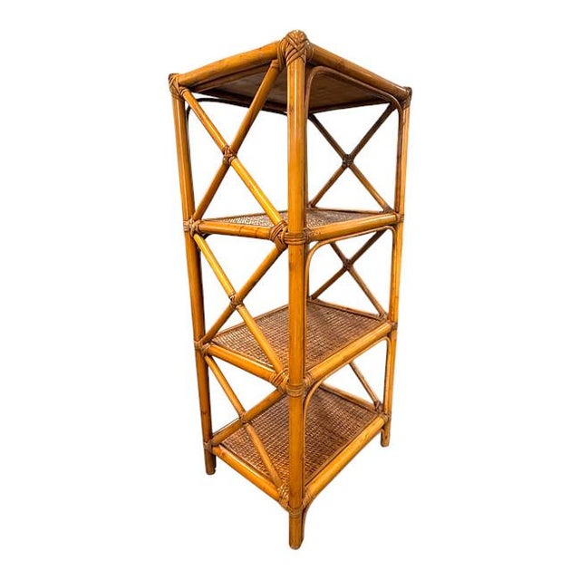 Elegant vintage bamboo and rattan étagère featuring a warm honey-toned finish, decorative X-shaped cross-bracing, and...