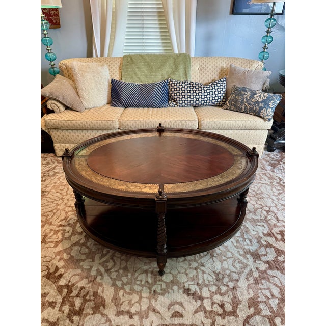 A refined mid-century coffee table marrying Jacobean Revival craftsmanship with the warmth of walnut and the subtle luxury...