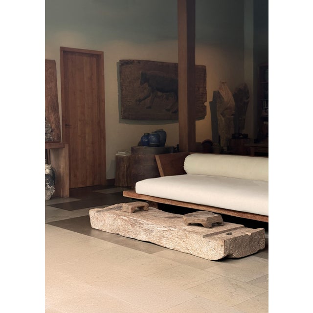 This striking low table is carved from a single solid block of wood, originally part of a traditional rice mortar used in...