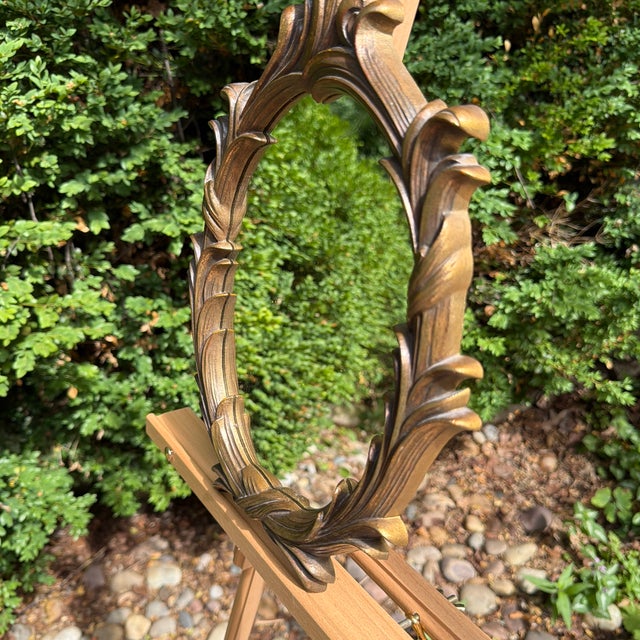 Infuse your home with sculptural, organic texture using this striking mid-century Hollywood Regency oval accent mirror....
