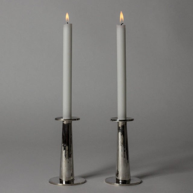 Pair of elegant silver candlesticks by Jarl Ölveborn, in a sleek modernist design. Hand hammered surface add a beautiful,...