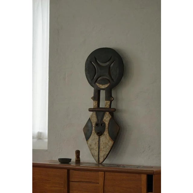 An authentic large wooden “plank” mask from the Nafana people of West Africa, mid-20th century. Hand-carved with bold...