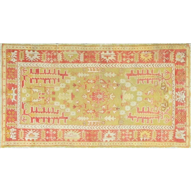 This charming antique Oushak rug displays the rustic elegance and artistic spontaneity that make village Oushaks so...