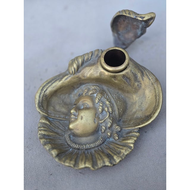 This is an exquisite heavy solid brass ink well with the ink trough intact. A lady head with a large hat with feathers and...