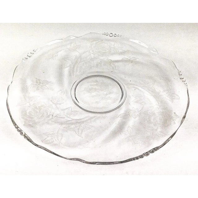 Crystal etched cake plate will certainly impress your guests. Roses are all over this large platter and only a few...