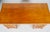 A distinctive double pedestal desk combining warm wood tones with richly textured bamboo-style detailing. The rectangular...