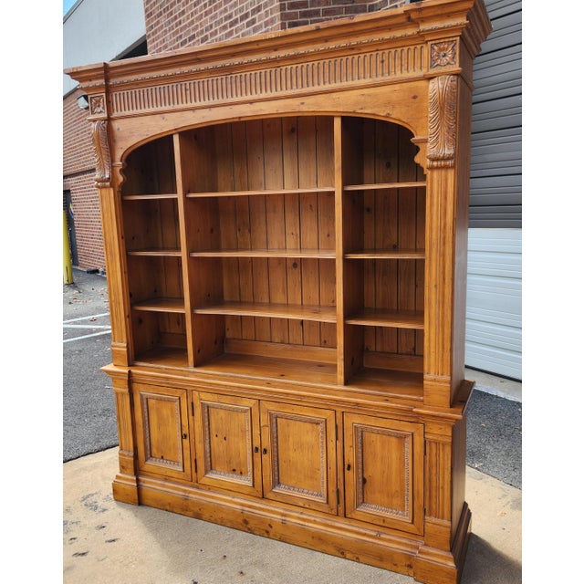 Massive hardwood bookshelf wall unit by Ethan Allen, offering substantial storage and display capacity with a classic...
