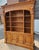 Massive hardwood bookshelf wall unit by Ethan Allen, offering substantial storage and display capacity with a classic...