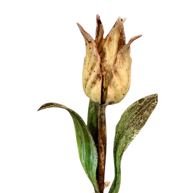 A charming, pair of Italian tole candleholders. Each features a statuesque tulip bloom surrounded by stylized green...