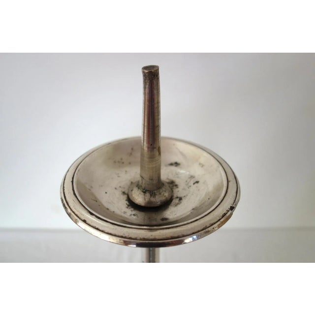 Silver-plated bronze candlestick, 19th century, France. Baluster shaft mounted on a tripod base. This candlestick is in...