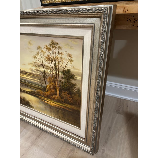 Offered is a vintage framed landscape oil print on canvas. This piece features a timeless scene with neutral colors and a...