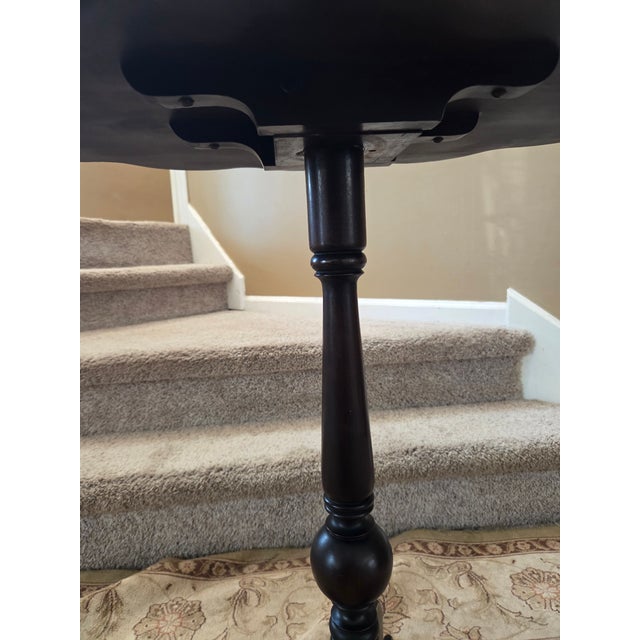 Very attractive pie crust table with beveled scalloped edged top, tri-pod base, claw feet and brass hinges. The tilt top...