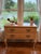Warm wood tones, graceful curves, and decorative ironwork give this Thomasville console a welcoming presence with...