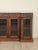 An English late Regency period rosewood breakfront cabinet, decorated with Neoclassical friezes on drawers and columns,...