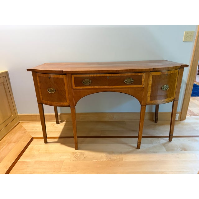 Antique Sheraton / Hepplewhite Style Inlaid Mahogany Bow-Front Sideboard An exceptionally elegant antique mahogany...