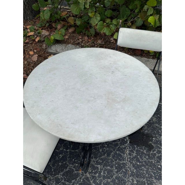 Exceptional vintage Maison Jansen–style outdoor bistro set featuring an ornate iron and brass frame paired with a gorgeous...
