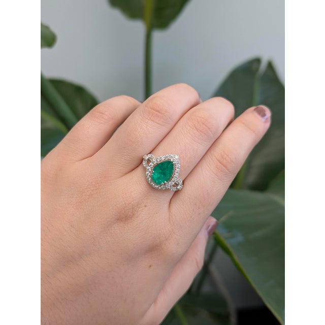GIA Certified 2.08cts Colombian Emerald Ring features a rich, vibrant green emerald that measures 10x8mm in a pear shape....