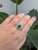 GIA Certified 2.08cts Colombian Emerald Ring features a rich, vibrant green emerald that measures 10x8mm in a pear shape....