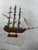 This is a wonderful vintage handmade model of a three-masted sailing ship, intricately constructed in wood with an...