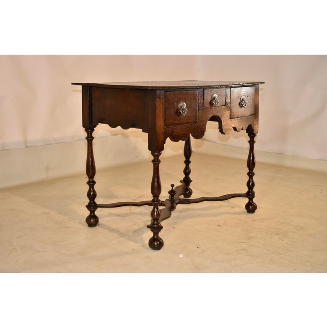 17th century oak lowboy from England, circa 1670-1690. The top on this piece has a lovely patina and a molded from edge....