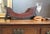 A fine Georgian Mahogany cheese coaster or cradle which features a slated bateau design and would accommodate a sizeable...