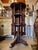 This is a unique piece. Hand carved Dark wood revolving shelf on whells. featuring intricate fretwork and design. It has 3...