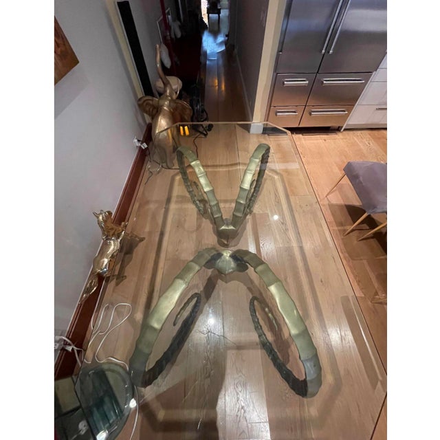 A stunning pair of 1970s vintage brass Ibex dining table pedestals in the style of renowned French designer Alain Chervet....