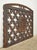 Reclaimed black cast iron grate with quatrefoil cutouts and a central floral medallion. The original use is unknown. Good...