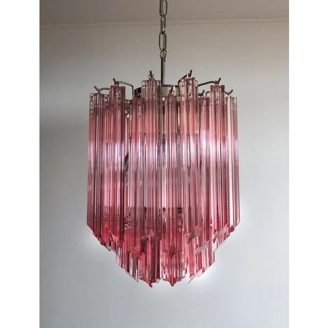 Trio Murano chandelier made by 47 Murano pink crystal prism "quadriedri" in a nickel metal frame. The glass are in 2...