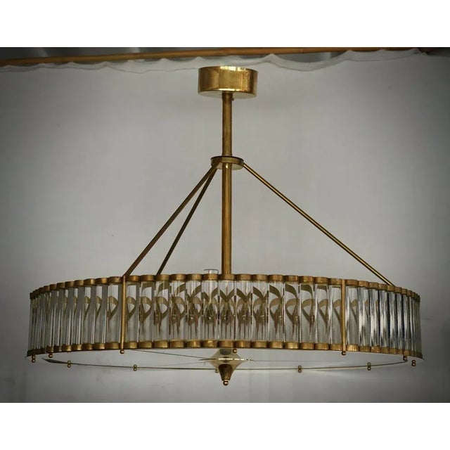 Fantastic round chandelier in Murano glass and polished brass. Note the shape of the rods with which it is formed. Murano...