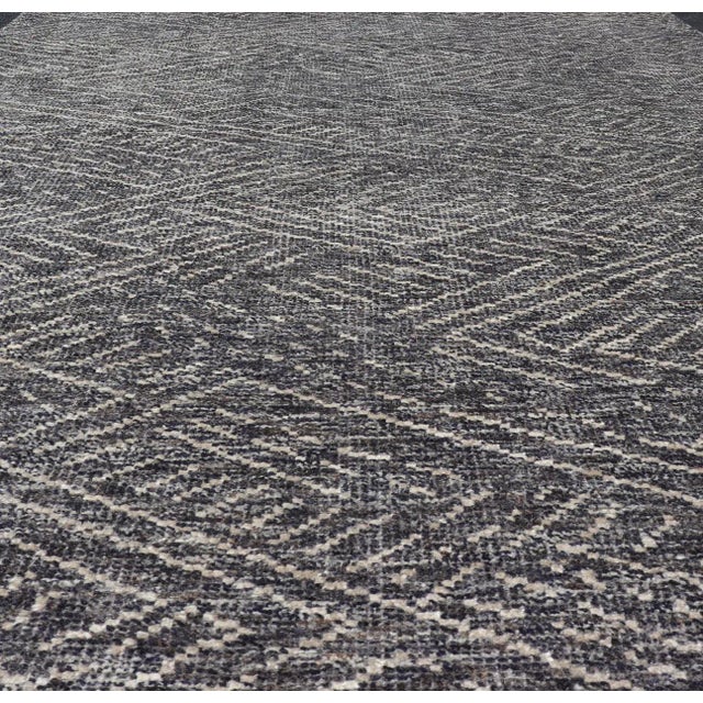 Measures 6 x 9 This modern Indian area rug features an abstract design loosely resembling a crosshatch design. The field...
