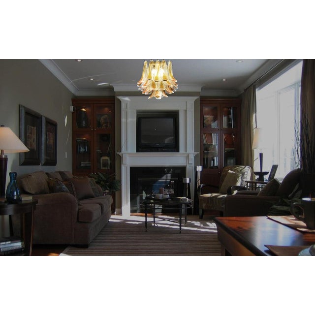 Spectacular ceiling lamp with 32 Murano glass petals (clear with amber spot) in golden painted metal frame. Elegant...