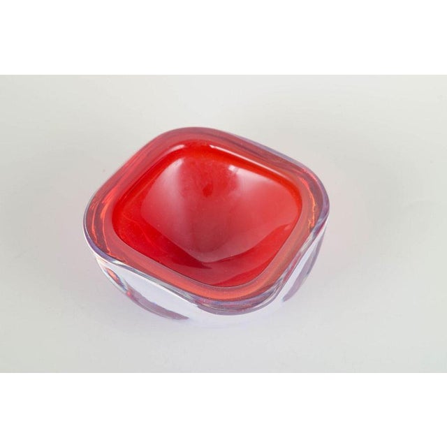 Murano art glass bowl, 1960s/70s. Organic freeform hand-blown bowl in layered sommerso technique, featuring a ruby red...