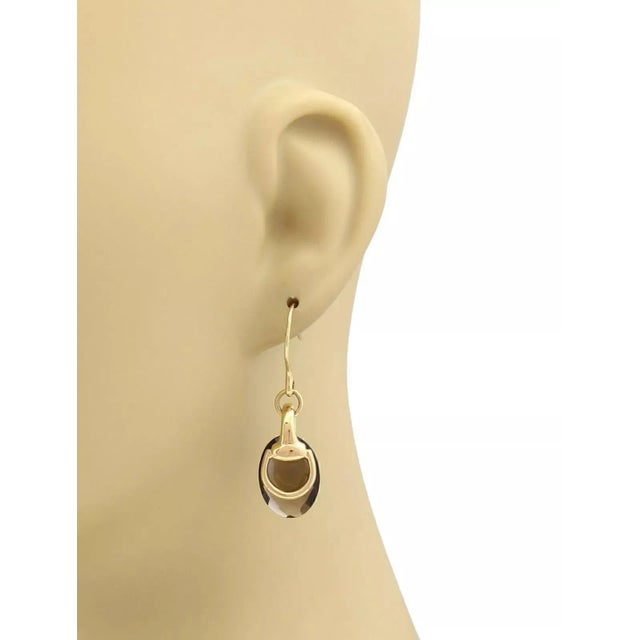 This lovely pair of authentic earrings are by designer Gucci, they are crafted from 18k yellow gold with a polished finish...