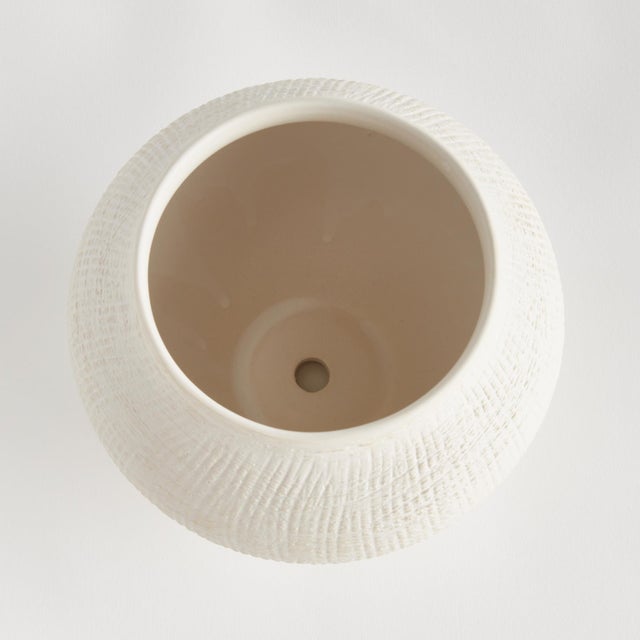 In a modern silhouette with a subtle crosshatch texture and matte finish, this ceramic pot is a stunning accent. Another...