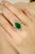 This elegant ring features a 4.62-carat pear-cut emerald at the center, surrounded by 2.64 carats of pear-cut diamonds in...