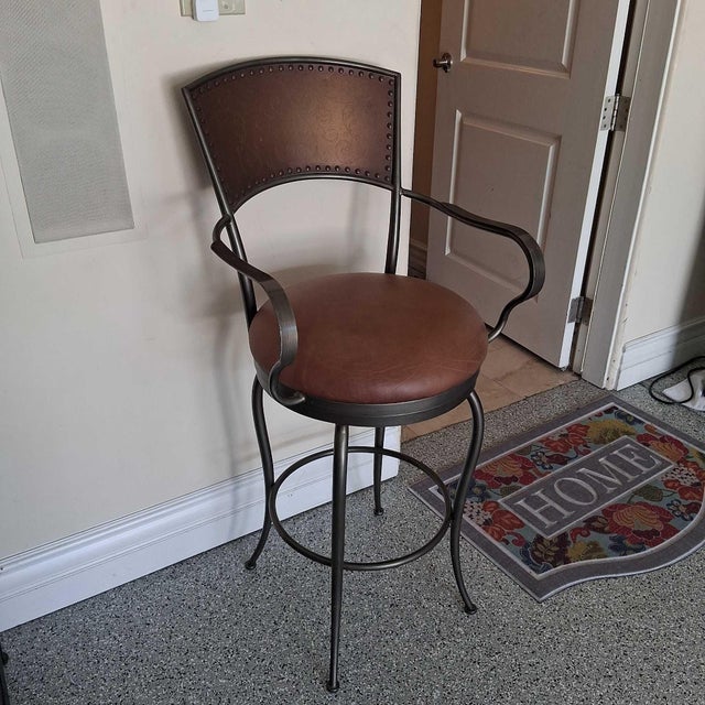 This Artistica Home dining chair features a strong metal frame with a comfortable padded brown seat and matching backrest....